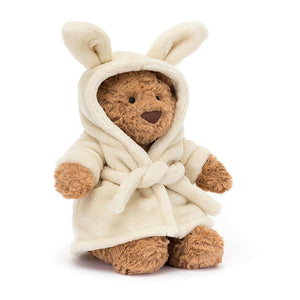 Jellycat Bartholomew Bear Bathrobe, with brown fur, wearing a soft, bunny-eared bathrobe.