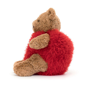 Side View: Jellycat Bartholomew Bear Heartthrob, a teddy bear wearing a red heart costume.