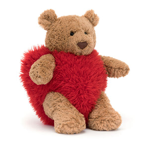 Angled View: Jellycat Bartholomew Bear Heartthrob, a cuddly teddy bear in a red heart costume.