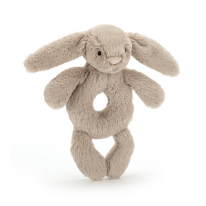 Ready to Rattle! The Jellycat Bashful Beige Bunny Ring Rattle, with its floppy ears and hidden rattle, is perfect for little hands to grasp and explore. (Angled view)