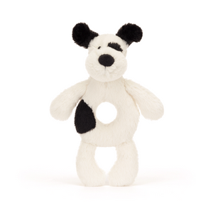 Shake, Rattle & Roll! The Jellycat Bashful Black & Cream Puppy Ring Rattle features a soft puppy with a hidden rattle for playful exploration. (Front view)