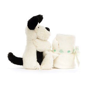 Portable Comfort & Soothing Play!  The Jellycat Bashful Black & Cream Puppy Soother's rolled-up blanket and playful design make it perfect for cuddling on the go. (Blanket rolled up, side view)