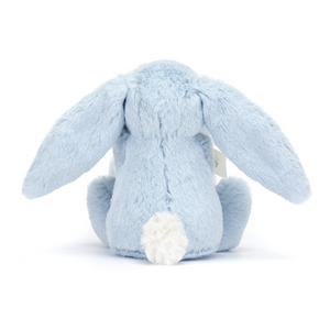 Backside view of the Jellycat Bashful Blue Bunny Soother, emphasizing its long floppy ears and white tail.