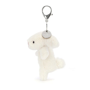 A side view of Jellycat Bashful Bunny showing the siver Jellycat tag. Cream Bag Charm