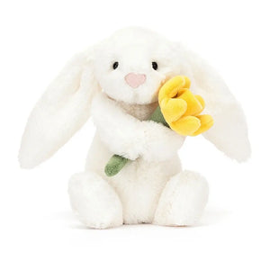 Meet Bashful Daffodil Bunny! This cuddly friend boasts double-cream fur & a bright daffodil, bringing springtime cheer wherever it goes.