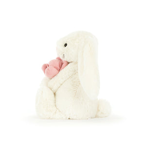 Side view of Jellycat Bashful Bunny ‘Peony’, showing its adorable profile and soft texture.