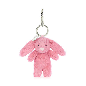 Pink bunny bag charm and keyring from Jellycat which is a cuddly fuzzy bunny covered in bright pink fur.
