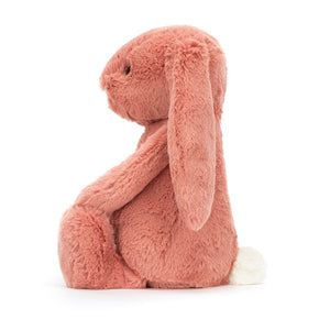 Side view of Jellycat Bashful Bunny Sorrel (available in small 18cm x 9cm and medium 31cm x 12cm), showcasing its soft pink fur, long floppy ears, and cute cream silky bobtail.