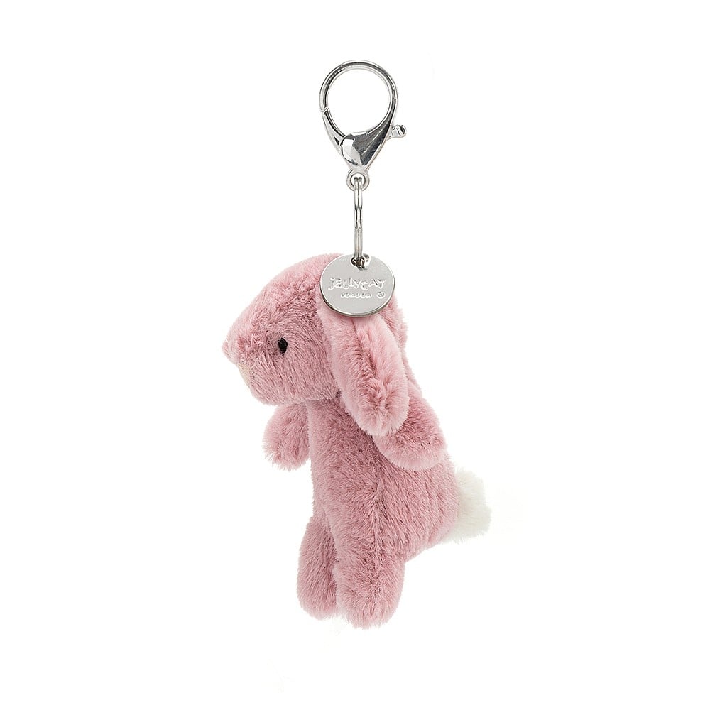 A side view of Bashful Bunny Tulip Bag Charm showing the silver Jellycat tag.