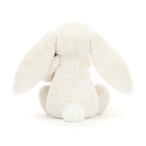 Behind: Back view of Jellycat Bashful Bunny plush toy, highlighting the full length of the bunny and its  fluffy tail.