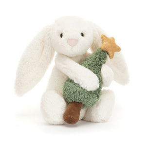 Product slightly to an angle: Jellycat Bashful Bunny plush toy with Christmas tree, shown in profile, highlighting its festive colours.