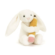 Angled View: Bashful Bunny with Pencil (18 cm x 9 cm): Adorable Jellycat bunny holding a textured pencil, perfect for a calming cuddle during exams or a fun desk buddy.