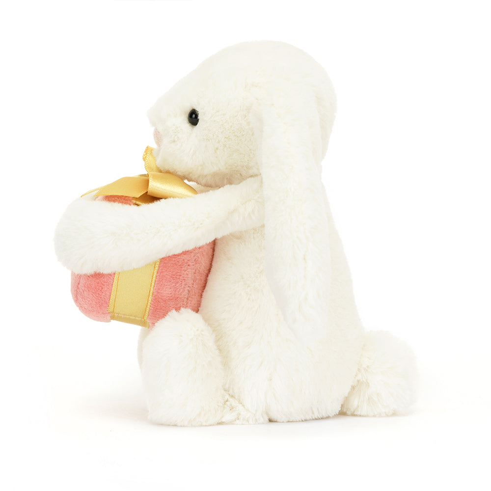 Side View: Cuddle up with the Jellycat Bashful Bunny! This soft bunny friend holds a delightful present, ready for adventures.