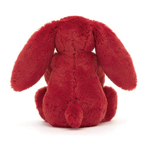 Back View: The back of a plush cranberry-coloured Christmas bunny toy, revealing its soft, textured fur and a small loop for hanging.