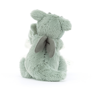  Backside view of the Jellycat Bashful Dragon Soother, emphasizing its soft moss-green fur tail and velour wings.