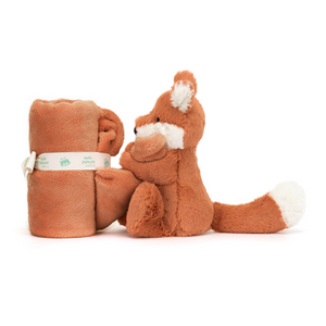 Snuggle Time with a Fox: The Jellycat Bashful Fox Cub Soother (rolled up) offers a cuddly fox friend with a comforting soother for bedtime snuggles or daytime adventures. (Side view)