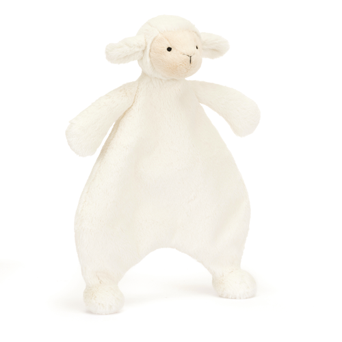 Jellycat Bashful Lamb Comforter at an angle, showcasing its soft vanilla cream fur made from recycled materials, unstuffed body perfect for little arms, and cute waggle ears.