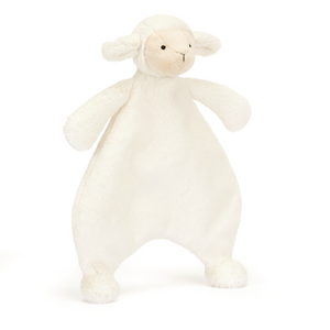 Jellycat Bashful Lamb Comforter at an angle, showcasing its soft vanilla cream fur made from recycled materials, unstuffed body perfect for little arms, and cute waggle ears.