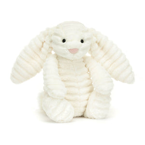 Angled View: Heavenly cuddles! The Jellycat Bashful Luxe Bunny Nimbus leans in, showcasing its luxurious double-cream plush with floppy ears and a silky tail. Glossy eyes and a dainty suedette nose complete the celestial look. Snuggle up to pure softness! 