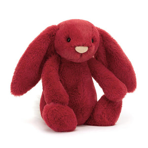 Product slightly to an angle: Jellycat Bashful Luxe Bunny Scarlett in profile, showing her holly-berry fur.