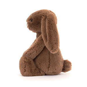 Side View: A side view of a cuddly nutmeg-coloured Christmas bunny toy, showcasing its three-dimensional shape.