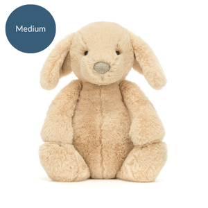 Jellycat Bashful Luxe Puppy Orlando (Medium) sitting upright, featuring its plush beige coat, floppy ears, and cute stitched nose.