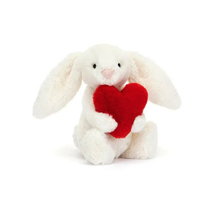 Cloud-soft Jellycat Bashful Red Love Heart Bunny tilts its head, holding a warm cranberry heart, ready for the sweetest cuddles.