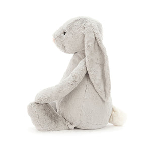 Side view of Jellycat Bashful Silver Bunny highlighting its fluffy silver coat, long ears, and playful sitting posture.