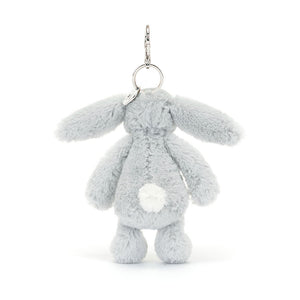 The rear view of the Jellycat Bashful Silver Bunny bag charm, displaying its fluffy white tail, long ears, and a soft grey body. The silver keyring and clip are attached at the top.