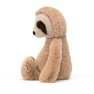 From the side Jellycat Bashful Sloth sits with his legs out in front and long arms by him side.