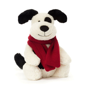 Product slightly to an angle: Jellycat Bashful Winter Puppy plush toy, showing his cream fur and black patches.