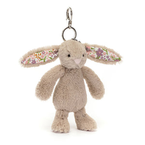 Front view of Jellycat Blossom Beige Bunny ‘Petal’ Bag Charm, showcasing its soft beige fur and floral-patterned ears.