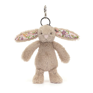 Angle view of Jellycat Blossom Beige Bunny ‘Petal’ Bag Charm, highlighting its cute face and cuddly design.