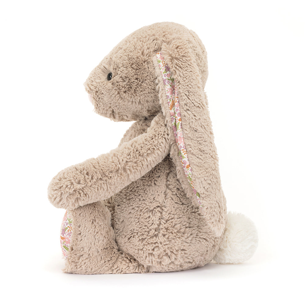 Side profile of Jellycat Blossom Beige Bunny ‘Petal,’ highlighting its floppy ears and cuddly plush body.