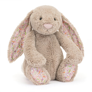 Jellycat Blossom Beige Bunny ‘Petal’ displayed at an angle, showcasing its soft beige fur and floral-patterned ears and paws.