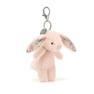 Spring has sprung! The Blossom Blush Bunny Charm boasts floral ears & a fluffy tail. Clip this soft pal onto your bag for a touch of whimsical charm.