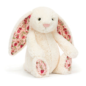 Angle view of Jellycat Blossom Cream Bunny ‘Berry’, highlighting its cute face and cuddly design.