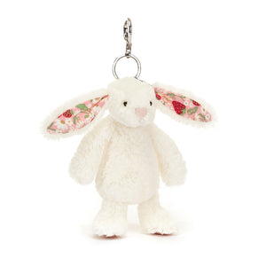 Angle view of Jellycat Blossom Cream Bunny ‘Berry’ Bag Charm, highlighting its cute face and cuddly design.