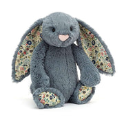 Dusky blue Jellycat Blossom Bunny cuddles close, revealing floral ears and paws - a vintage-inspired friend for all ages.