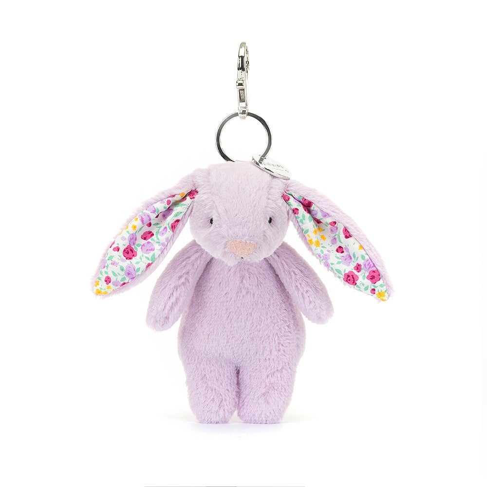 Perky Jellycat Jasmine Bunny charm boasts soft purple fur, ditsy-print ears & charming bobtail - the perfect bag accessory.