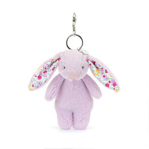 Perky Jellycat Jasmine Bunny charm boasts soft purple fur, ditsy-print ears & charming bobtail - the perfect bag accessory.