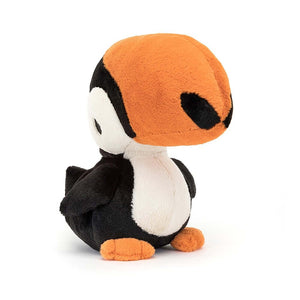 A vibrant Jellycat Bodacious Beak Toucan perched at an angle, showcasing its tangerine, cream, and liquorice fur, perky tail, and oversized beak.