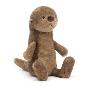 Angled view:  Jellycat Brooke Otter playfully tilted, showcasing its soft mottled fudge fur, butterscotch ears, and bright black eyes. Perfect for cuddling and otter-ly fun adventures.