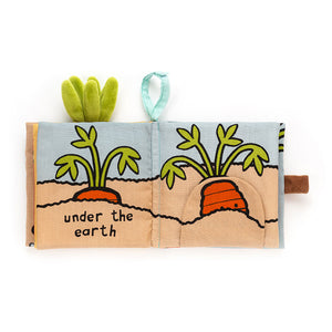 Inside pages of the Jellycat Carrot Book, showing an illustrated carrot growing underground with playful text and crinkly sensory elements.