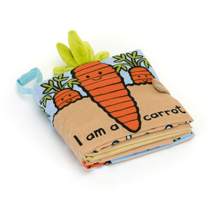 Jellycat Carrot Book folded to showcase its soft fabric pages, interactive elements, and bright illustrations of a carrot garden.