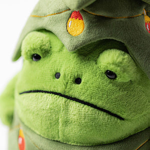 Close-up of Jellycat Christmas Tree Ricky Rain Frog showing its soft green plush texture, embroidered light detail, and signature grumpy expression.