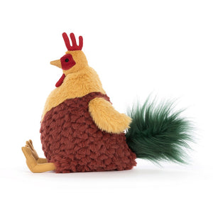 Jellycat Cluny Cockerel plush toy, side view showcasing its green tail feathers and quirky pineapple-like shape.