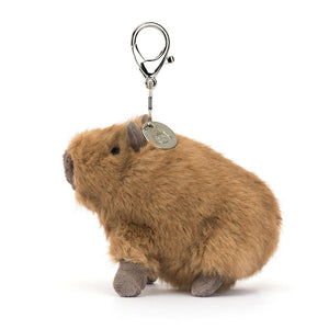 Side profile of the Jellycat Clyde Capybara Bag Charm, showing its compact size and silver claw clip attachment.