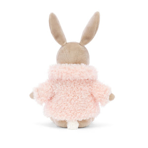 Jellycat Comfy Coat Bunny plush from the back, emphasizing its soft mallow-pink coat with a ribbon closure.