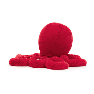 Side view of Jellycat Cranberry Octopus plush toy, highlighting the texture of its mantle and the candy-cane stripes.